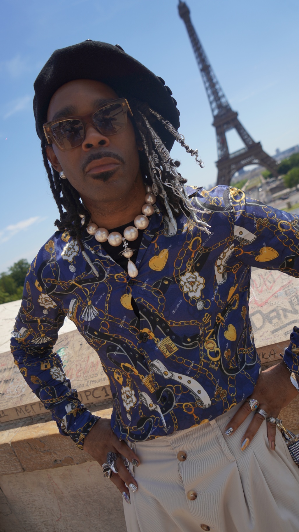 FYRE. against Eiffel Tower, hand on hip
